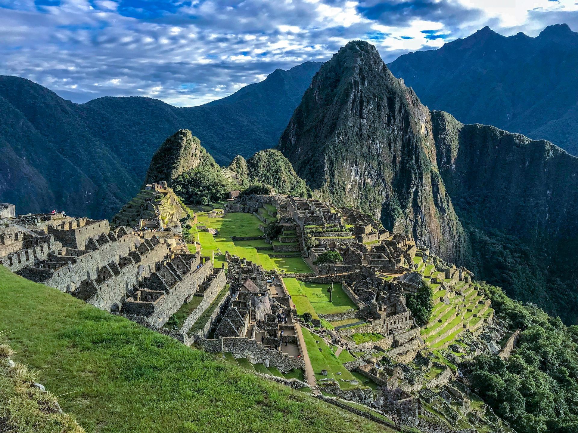 Machu Picchu ruins nestled in green mountains, Peru.