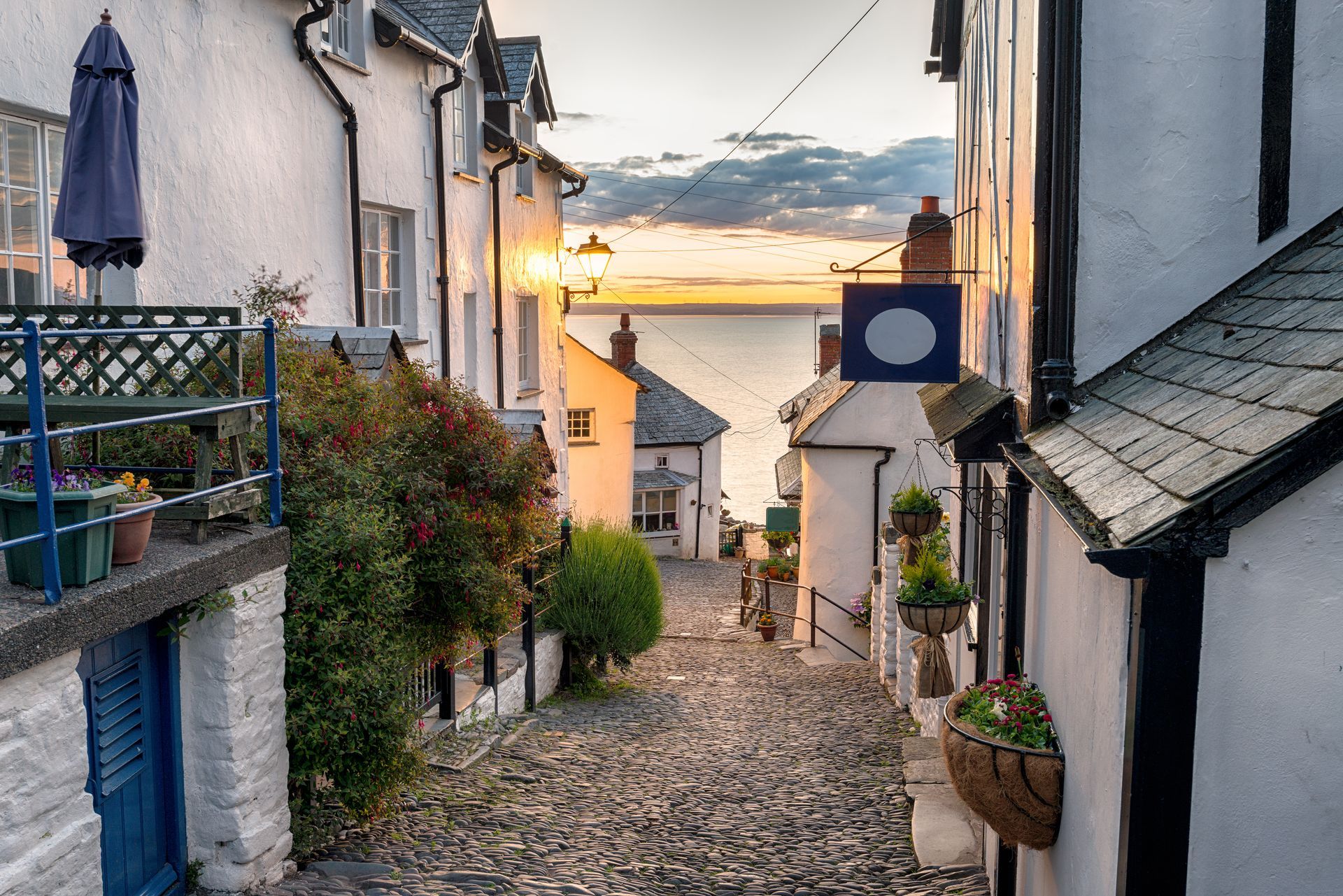 A narrow cobblestone street with a sign that says ' oyster ' on it