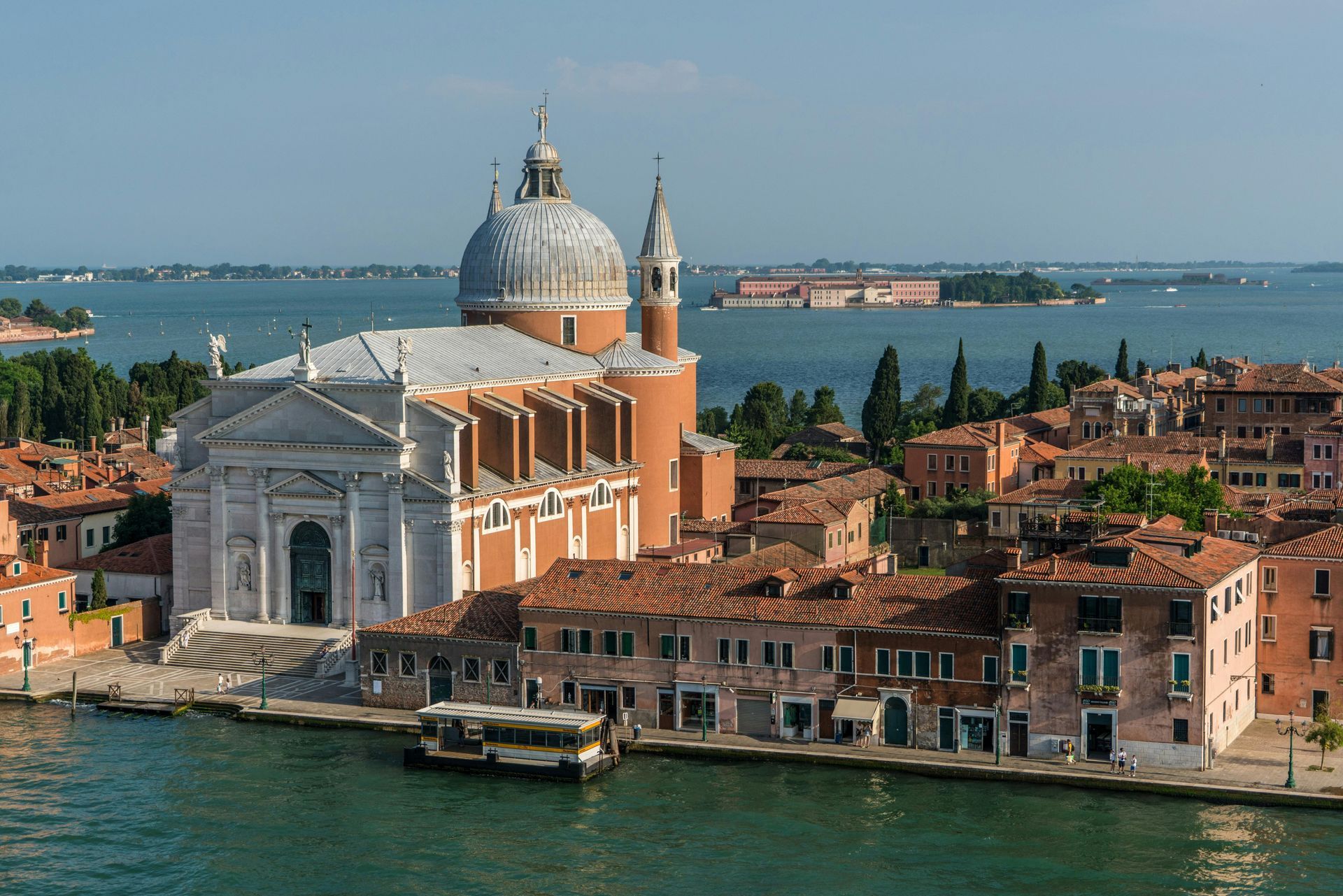 Venice, Italy: Basilica di San Giorgio Maggiore with orange rooftops and water.