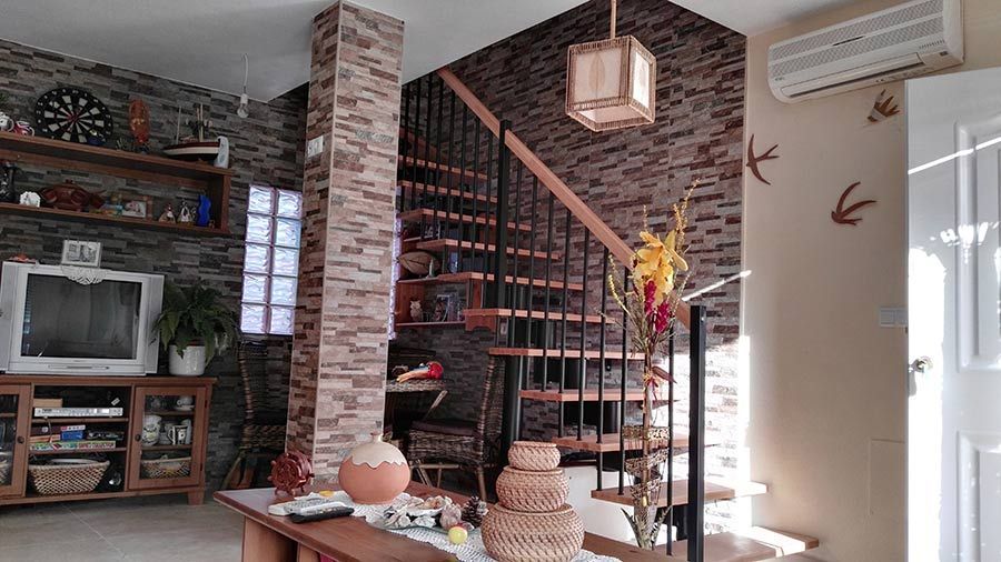 Una sala de estar con una escalera de caracol y un televisor.