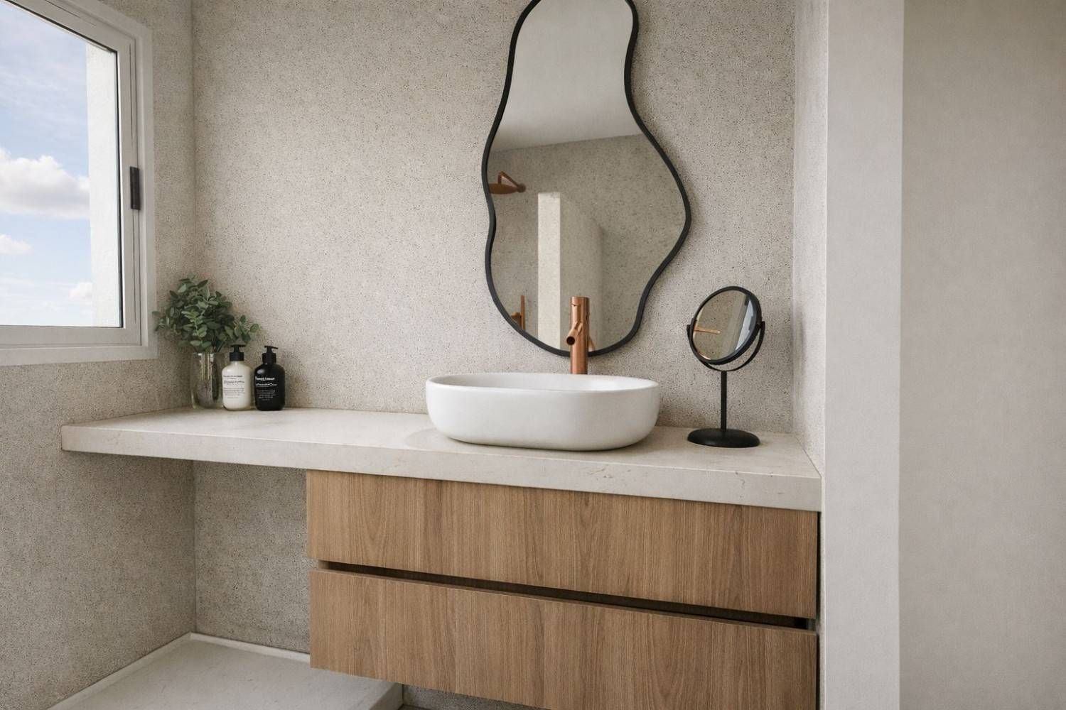 Mueble de baño minimalista con lavabo blanco, armarios de madera y espejo de pared ondulado.