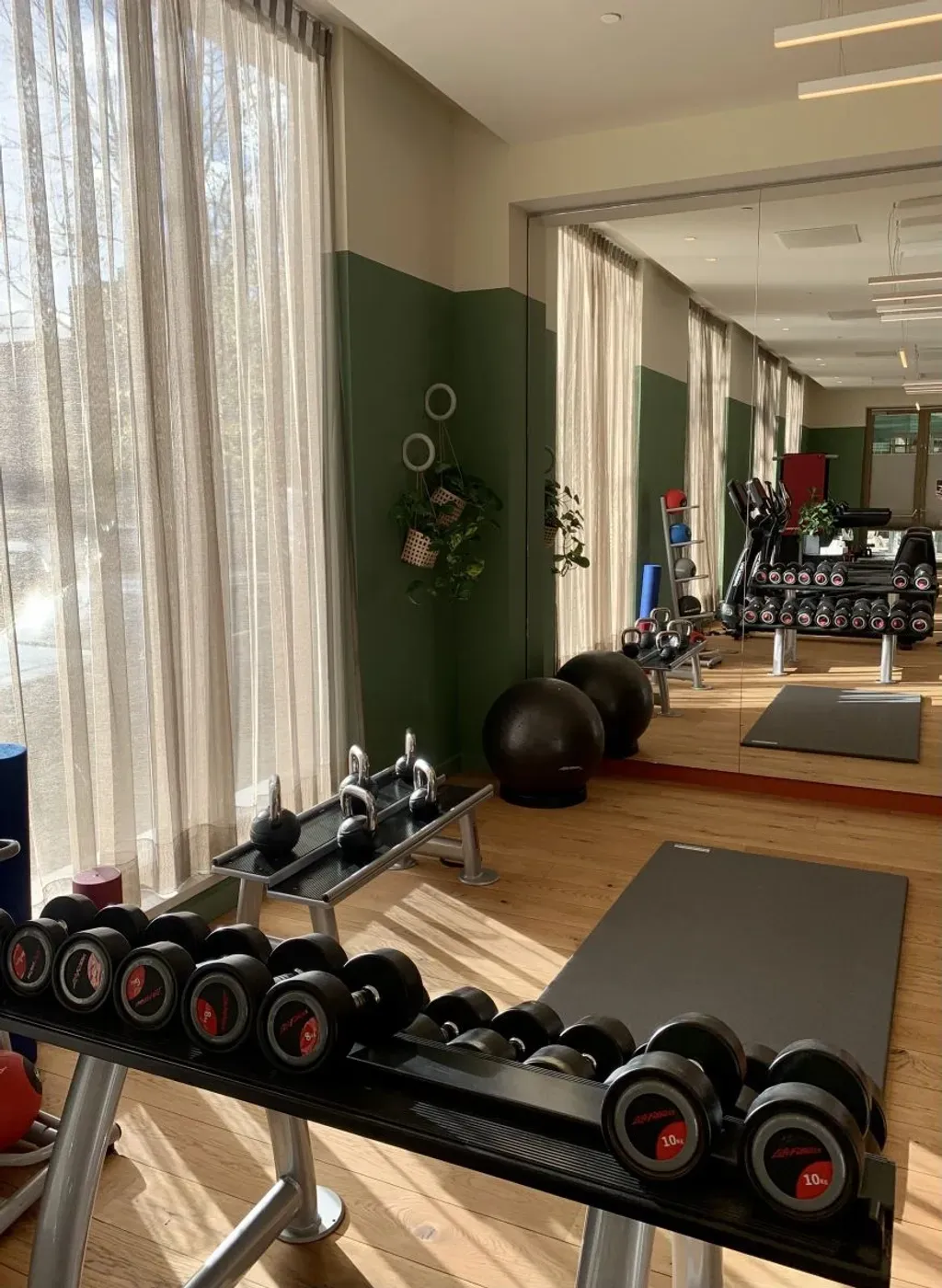 Hyatt Regency gym with a lot of dumbbells and a large mirror.