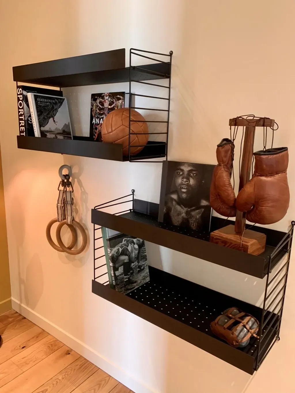 A shelf with boxing gloves and a basketball on it.
