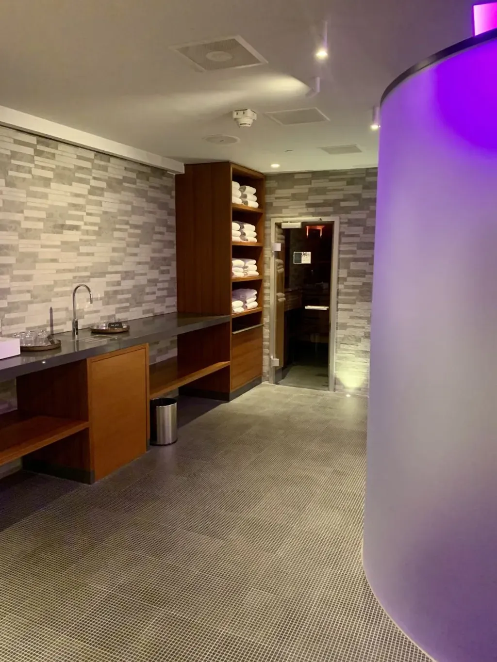 Hyatt Regency Wellness with a purple light on the wall and a sink.