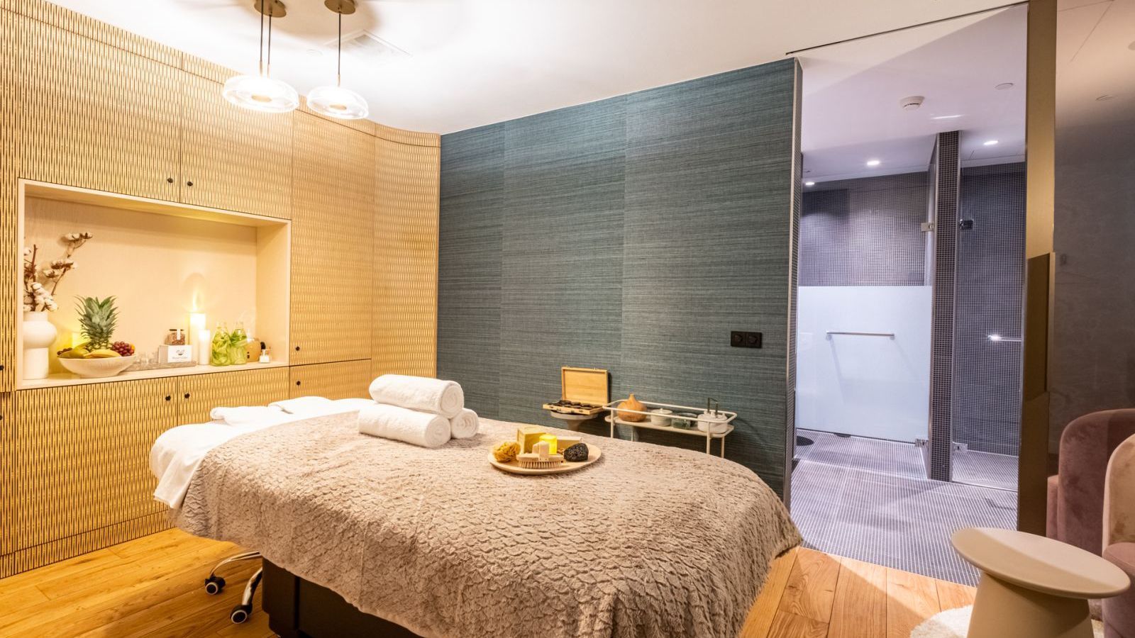 There is a massage table in the middle of the room.