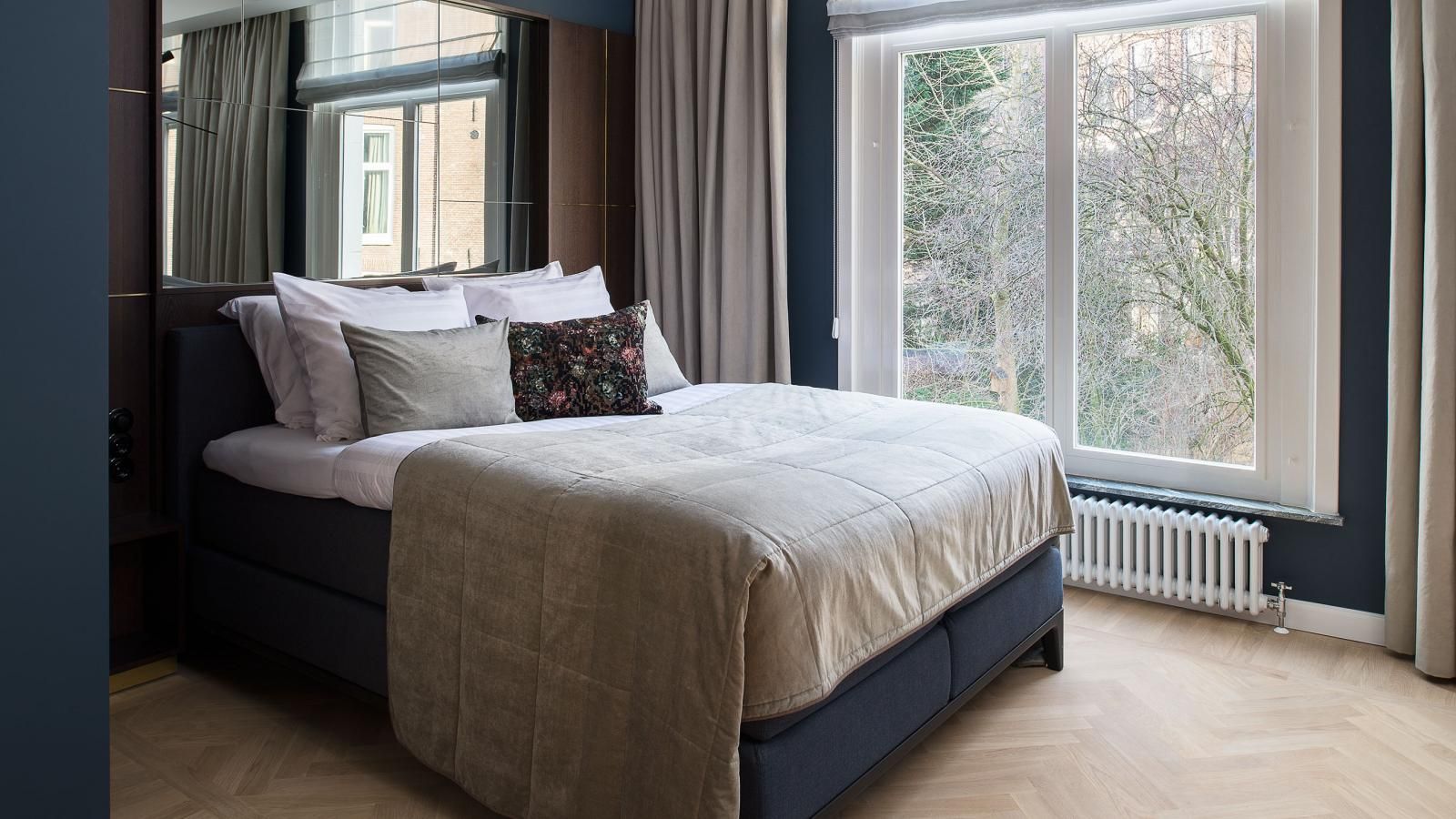 Garden Suite with a large bed and a large window.