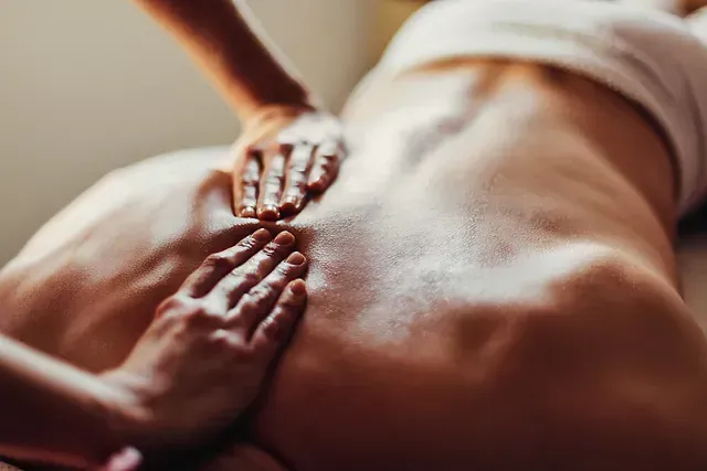 Una mujer está recibiendo un masaje en la espalda en un spa.