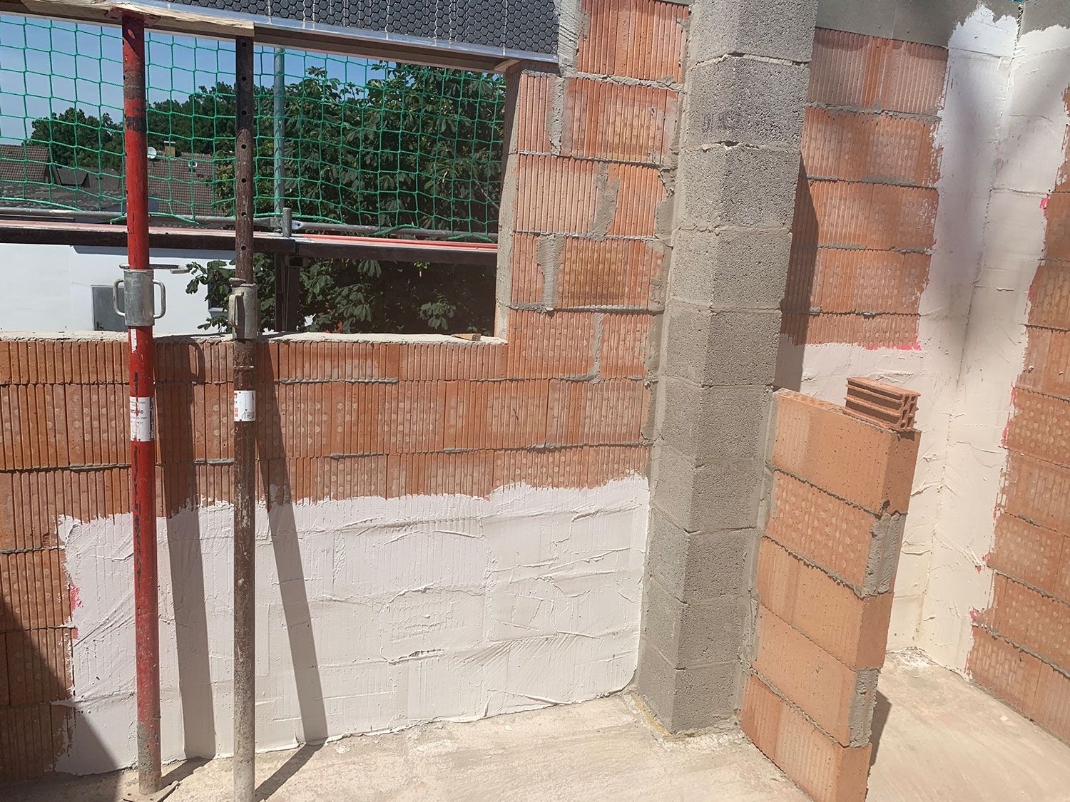 Ein im Bau befindliches Gebäude mit Backsteinmauern und einem Fenster.