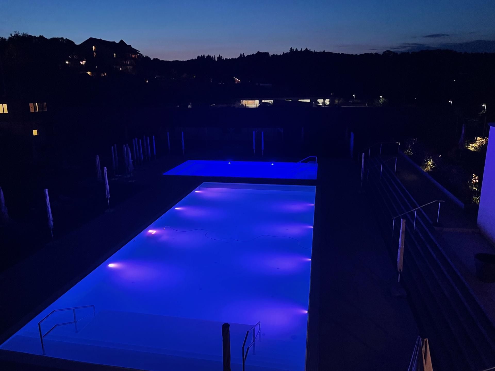 Ein großer Pool ist nachts beleuchtet