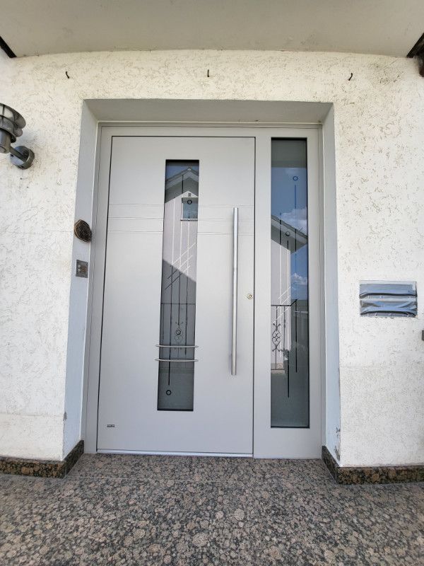 eine weiße Haustür mit einem silbernen Griff