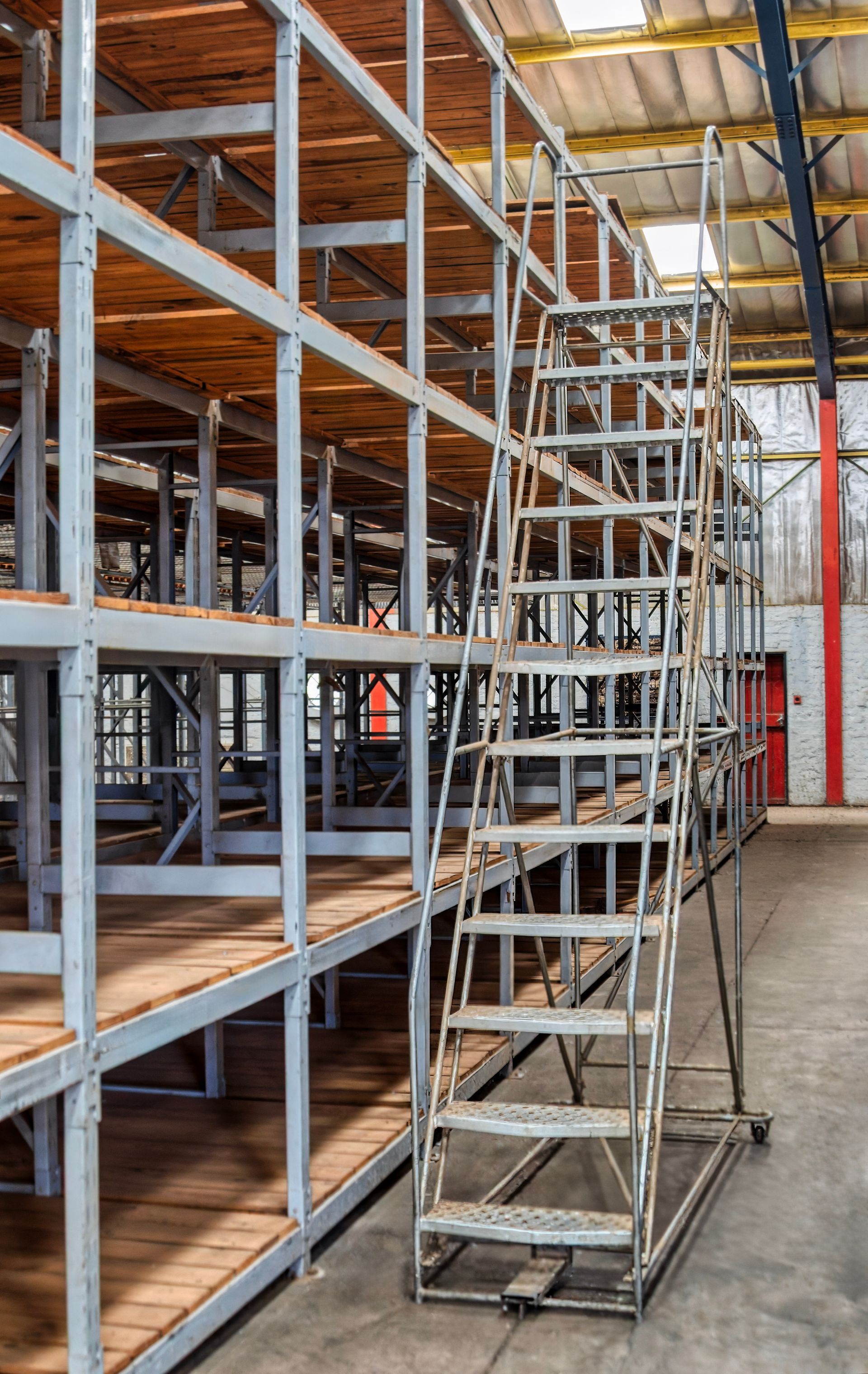 Étagère métallique avec escalier intégré dans un entrepôt.