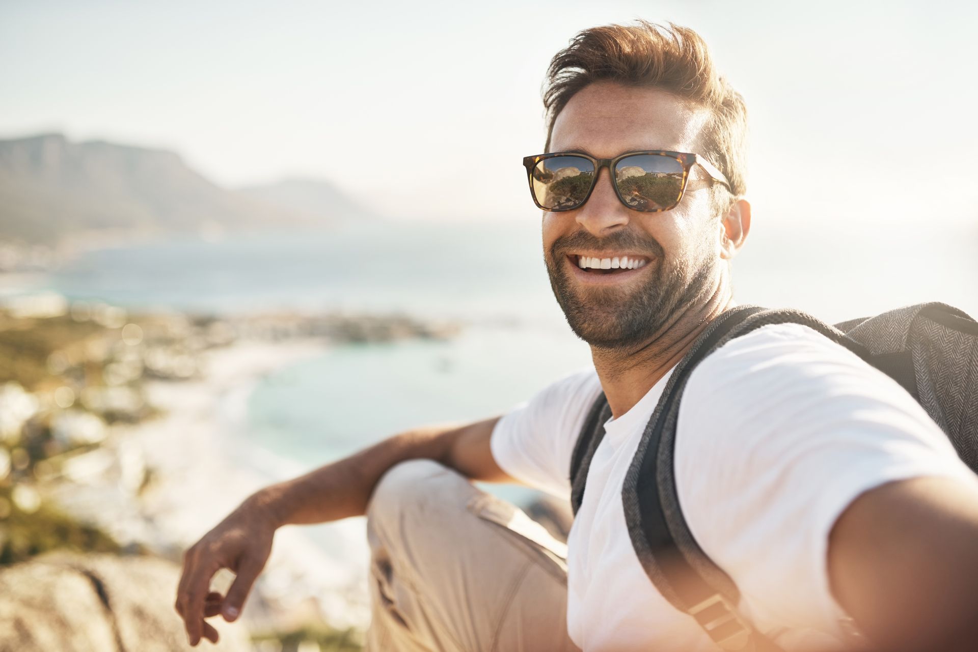 Homme souriant avec lunettes de soleil
