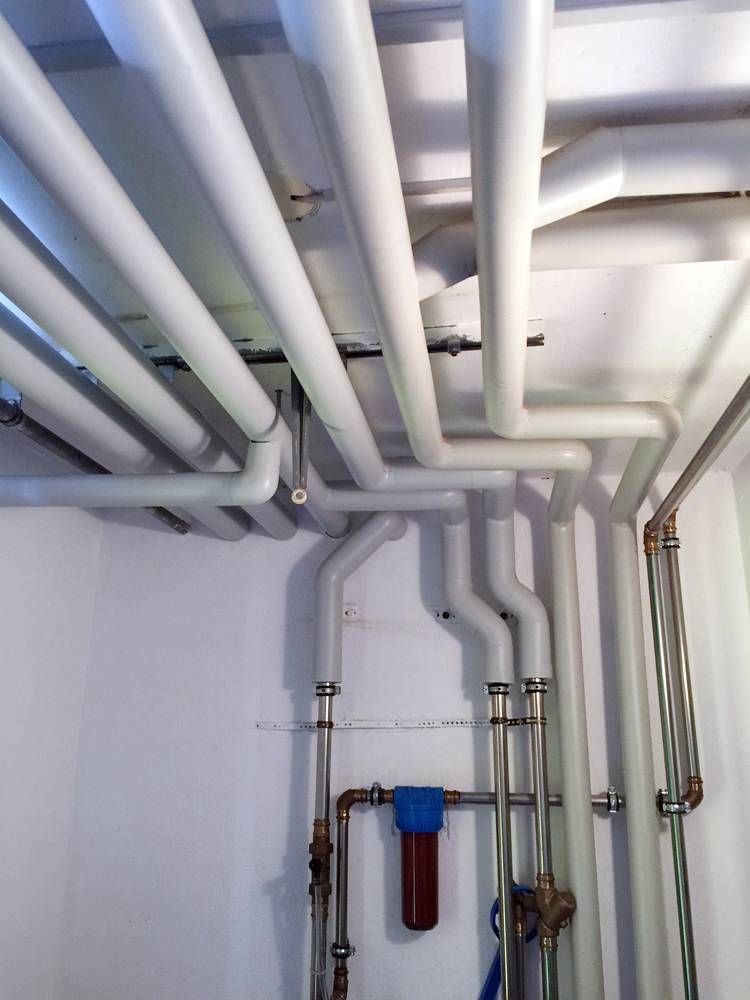 Une pièce avec des tuyaux blancs et un filtre bleu | Vincent Bourdin Sàrl