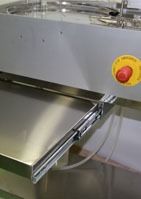 Una encimera de acero inoxidable con un botón rojo.