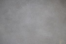 Un primer plano de un trozo de papel con una textura gris.