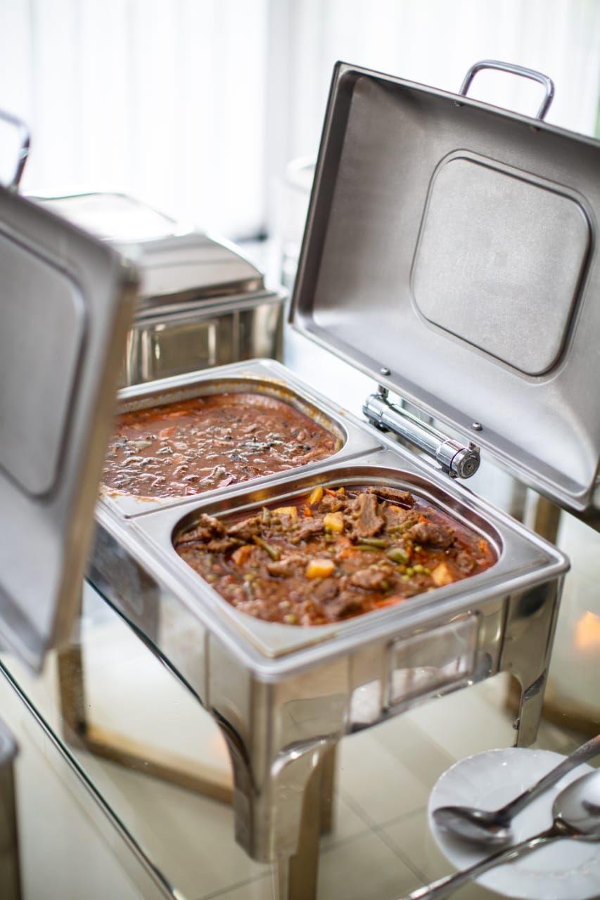 a buffet table with two trays of food on it .