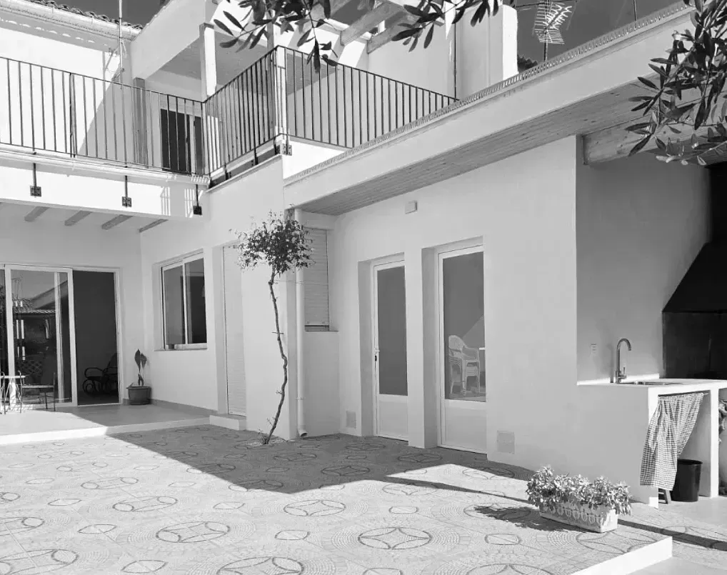 Una foto en blanco y negro de una casa con balcón.