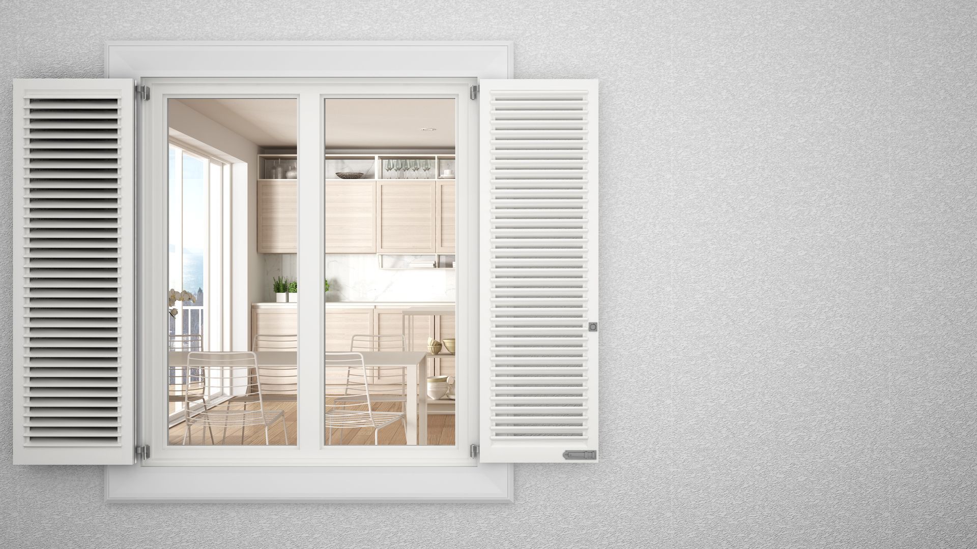 Des volets blancs ouverts dévoilent une cuisine moderne et lumineuse à l'intérieur.