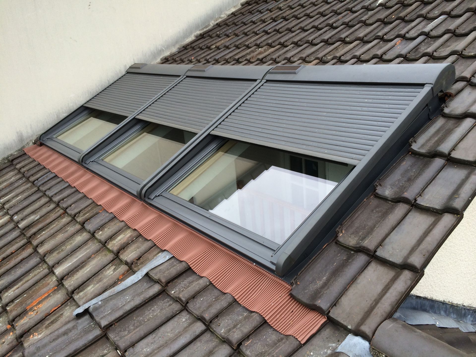 Trois fenêtres de toit munies de volets roulants extérieurs