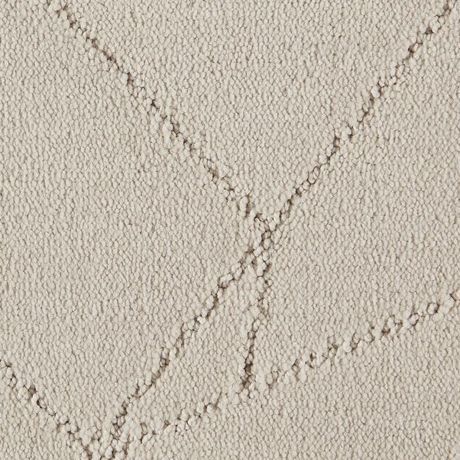 Eine Nahaufnahme eines weißen Teppichs mit einem Muster darauf.