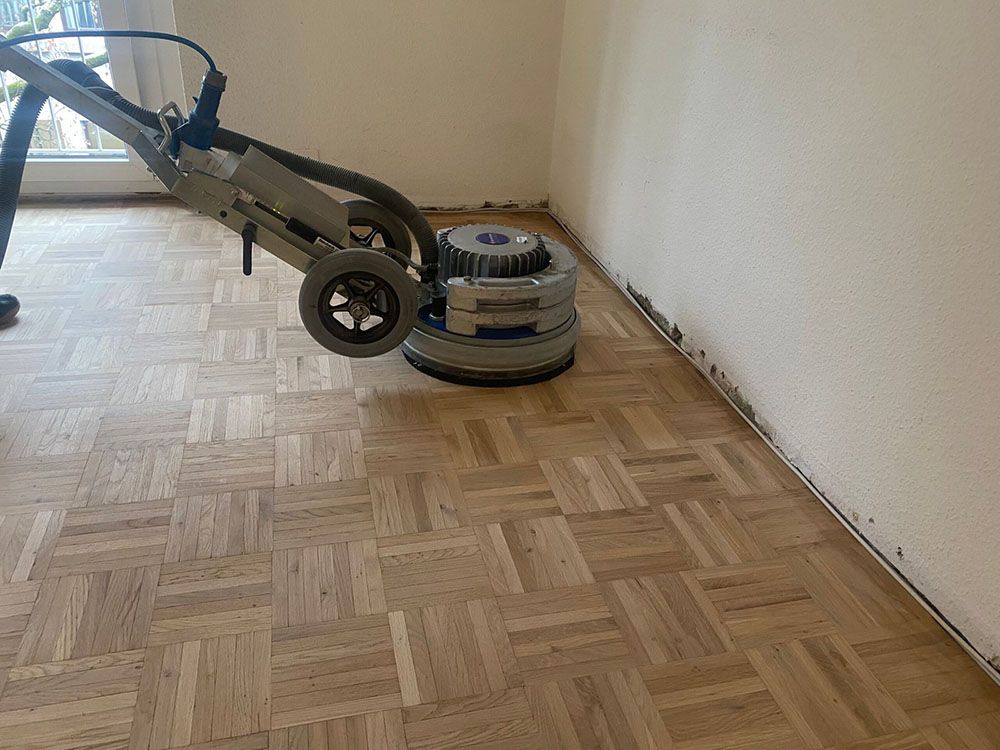 Eine Maschine steht auf einem Holzboden in einem Raum.