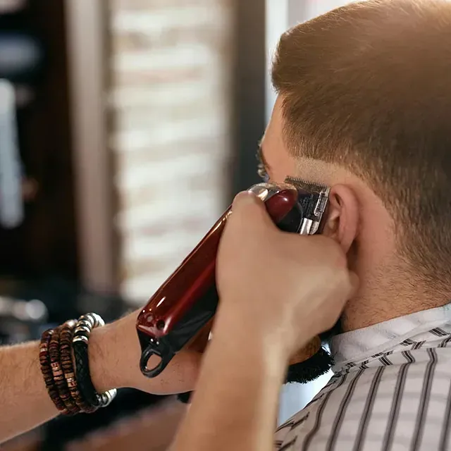 Un hombre se está cortando el pelo en un barbero.