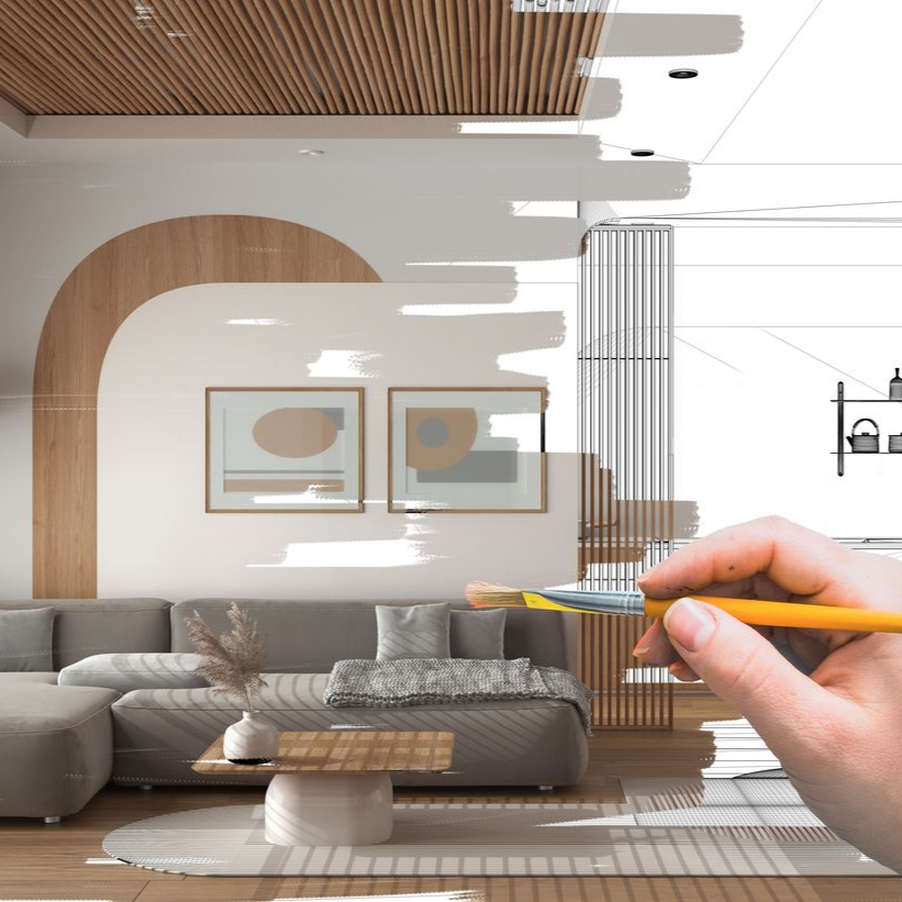 Une main utilise un pinceau pour colorier un dessin au trait représentant un salon moderne avec un canapé.