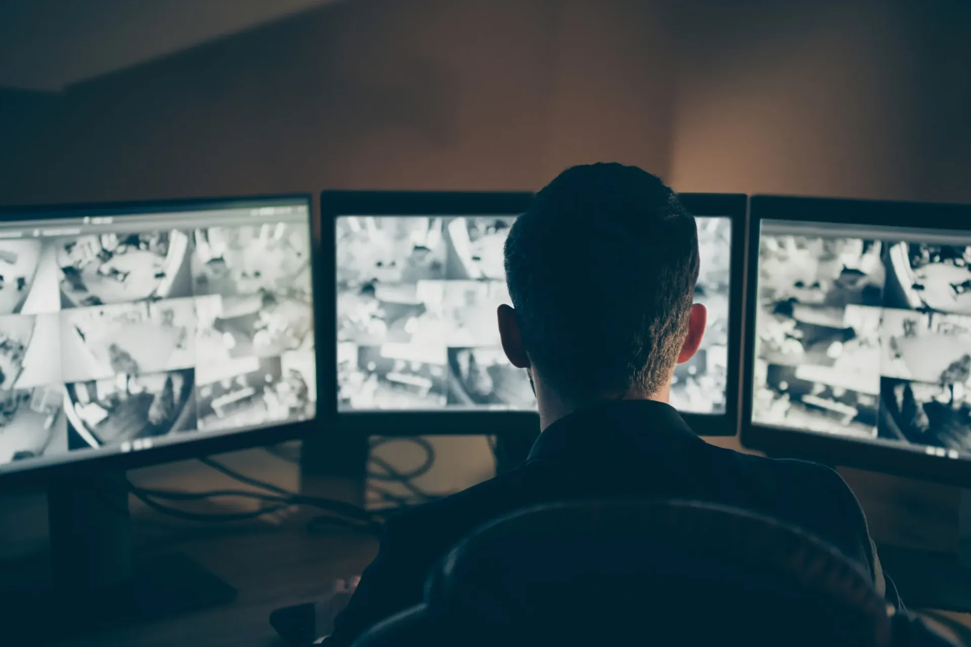 Personal uniformado monitorea las pantallas del sitio de construcción dentro de una sala de control.