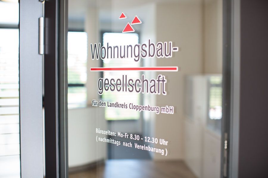 A glass door with the words wohnungsbau gesellschaft written on it