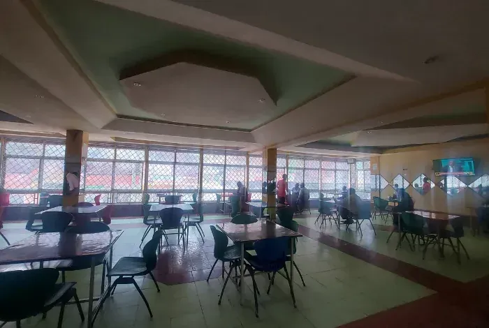 A large room with tables and chairs in a restaurant.