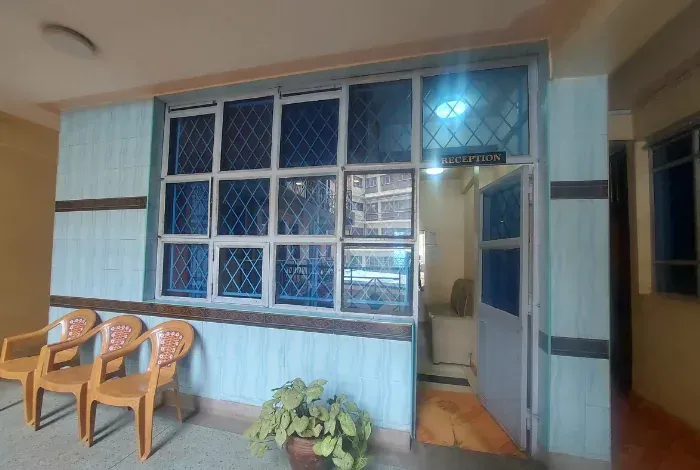 A room with a lot of windows and chairs in it.