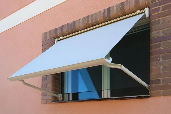 Una ventana con un toldo blanco.