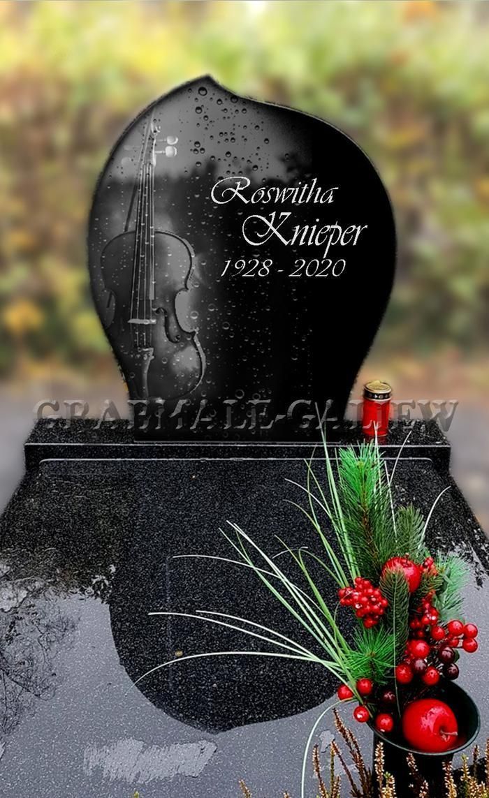 Ein schwarzer Grabstein mit einer Geige darauf
