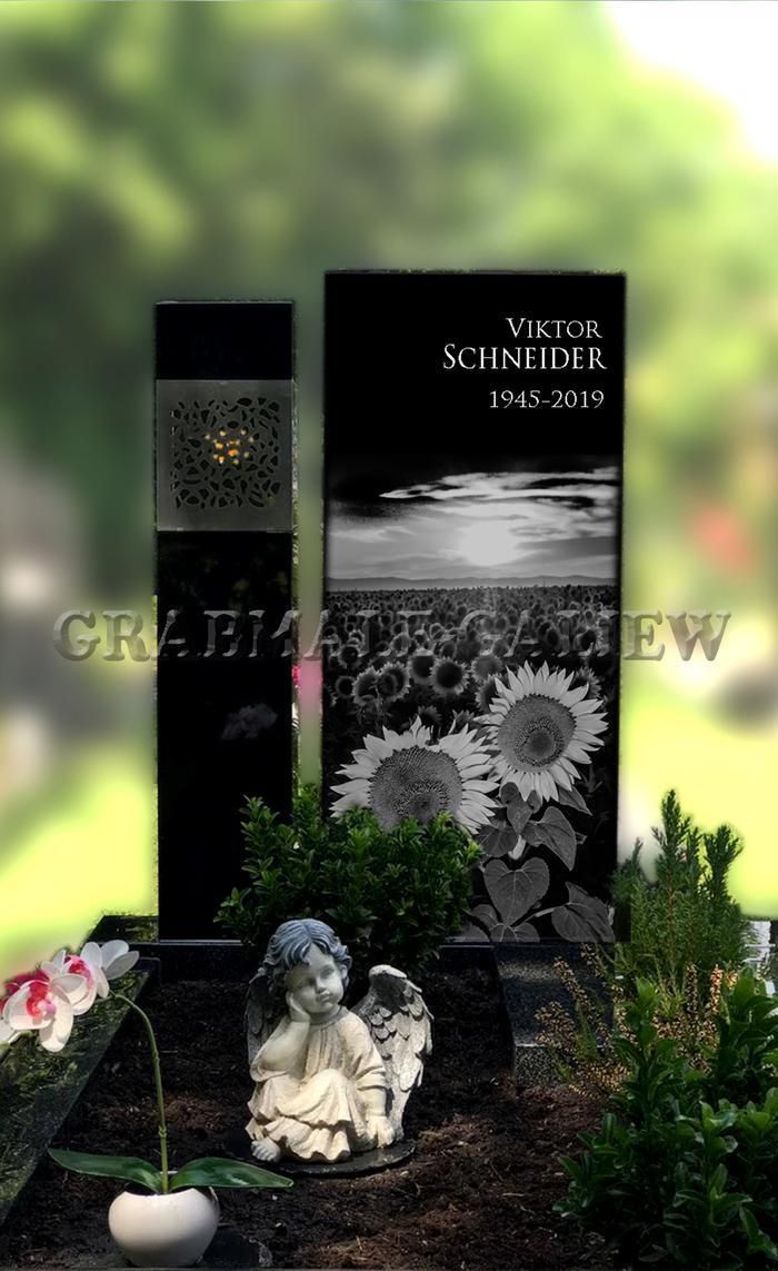 Ein Grab mit einer Engelsstatue und Sonnenblumen darauf