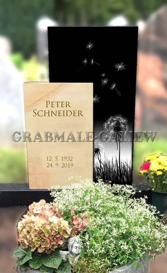 Ein Grabstein mit Blumen und einem Buch darauf auf einem Friedhof.