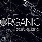 Logotipo para salón de peluquería "ORGANIC perruqueria" sobre fondo de mármol negro.