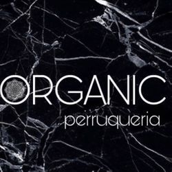 Logotipo para salón de peluquería "ORGANIC perruqueria" sobre fondo de mármol negro.