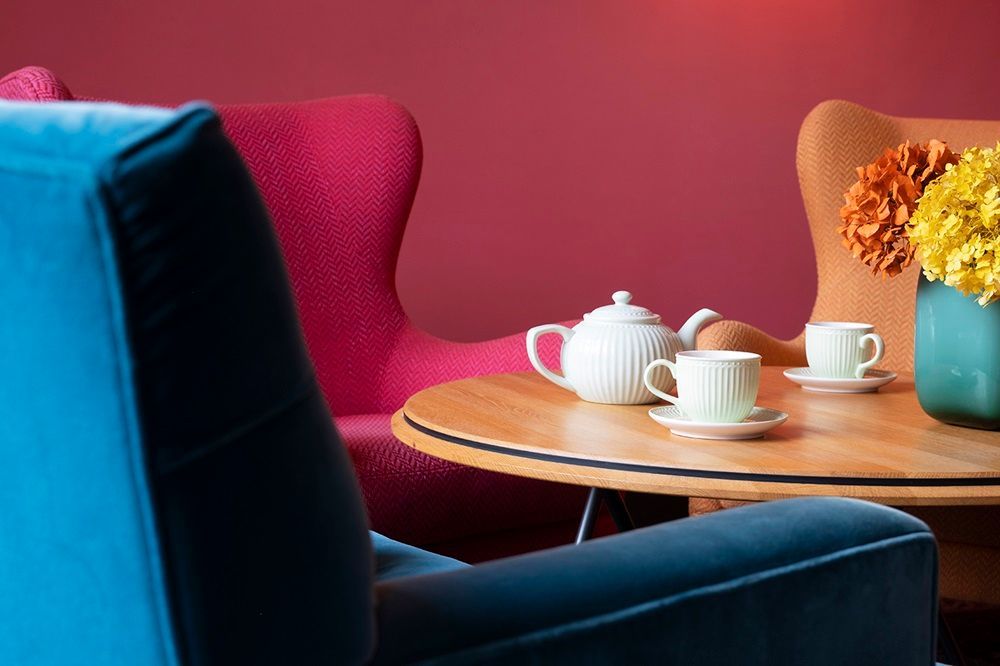 Ein Tisch mit einer Teekanne, Tassen und Untertassen darauf.