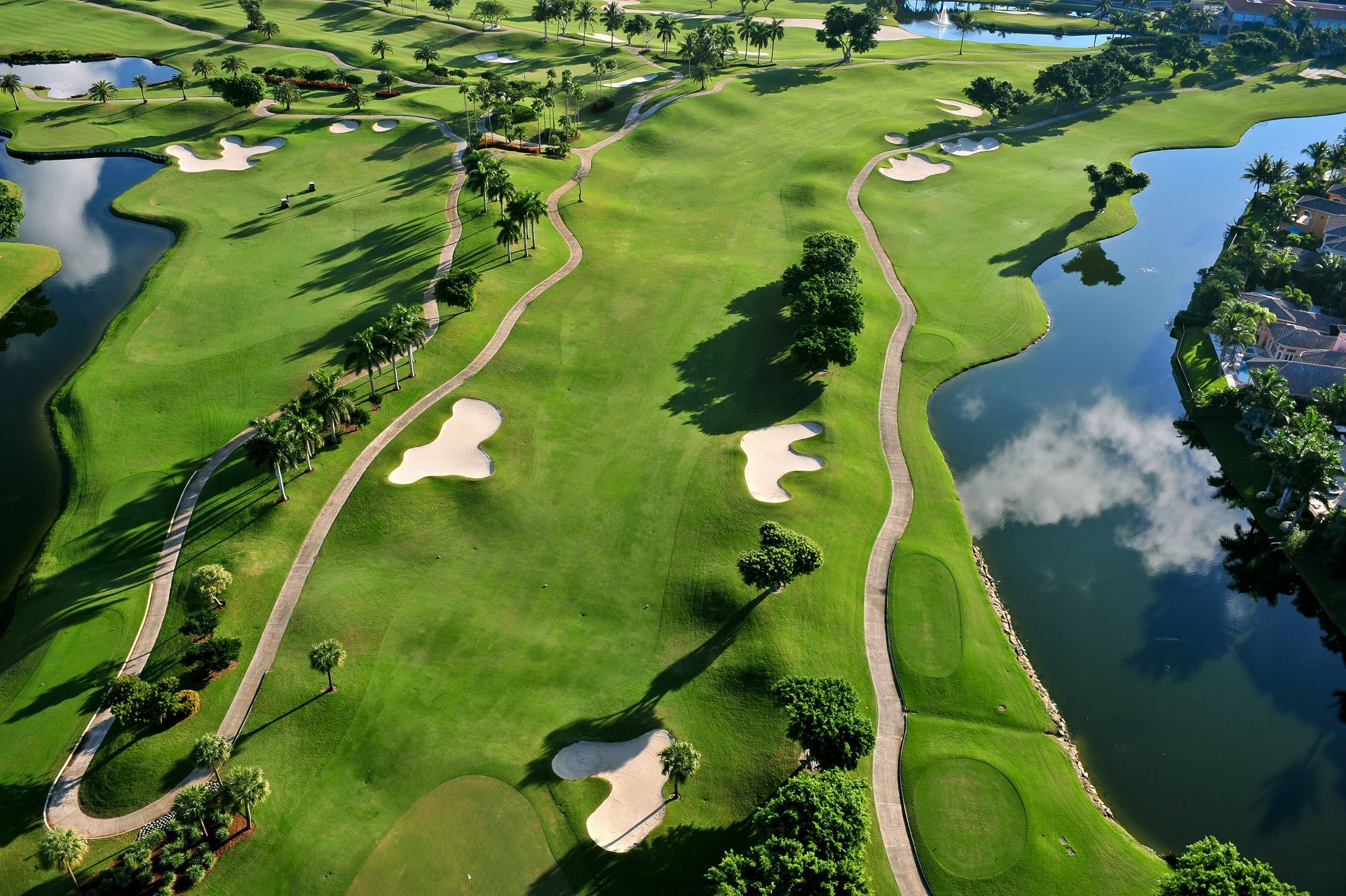 An aerial view of a golf course with a lake in the middle