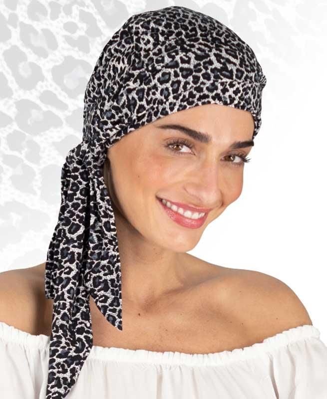 Eine Frau, die ein schwarz-weißes Kopftuch mit Leopardenmuster trägt
