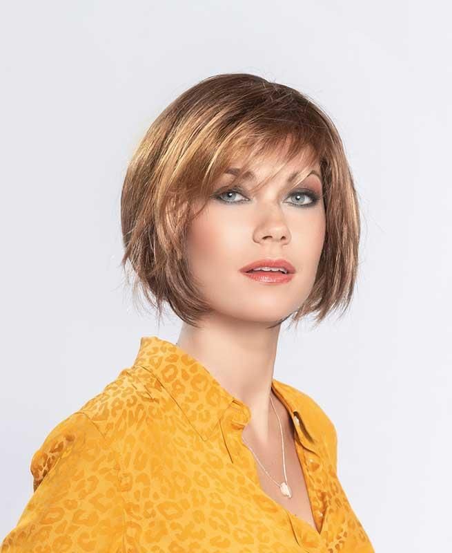 Eine Frau mit Perücke und gelbem Hemd