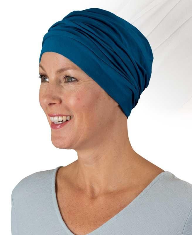 Eine Frau mit blauem Turban lächelt