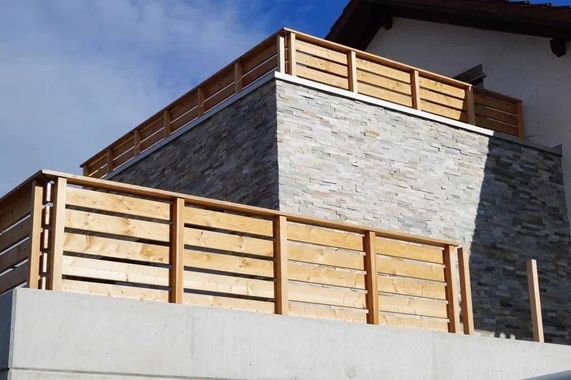 Modernes Badezimmerwaschbecken mit goldener Armatur, rundem Becken und Handtuchhalter neben einem Dachfenster