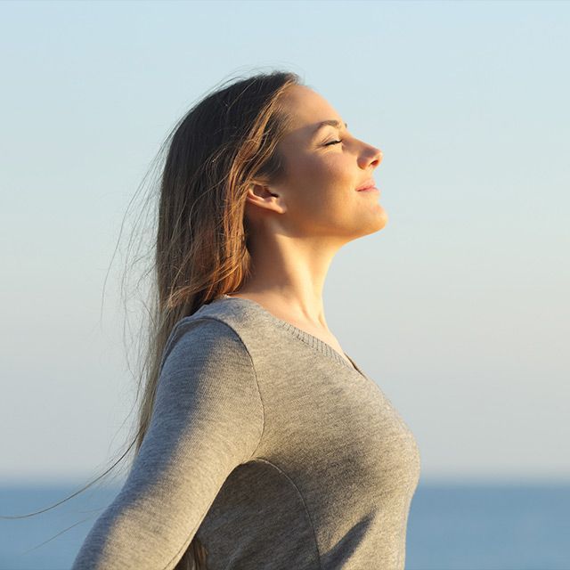 Un grupo de personas está sentada sobre colchonetas de yoga en posición de loto.