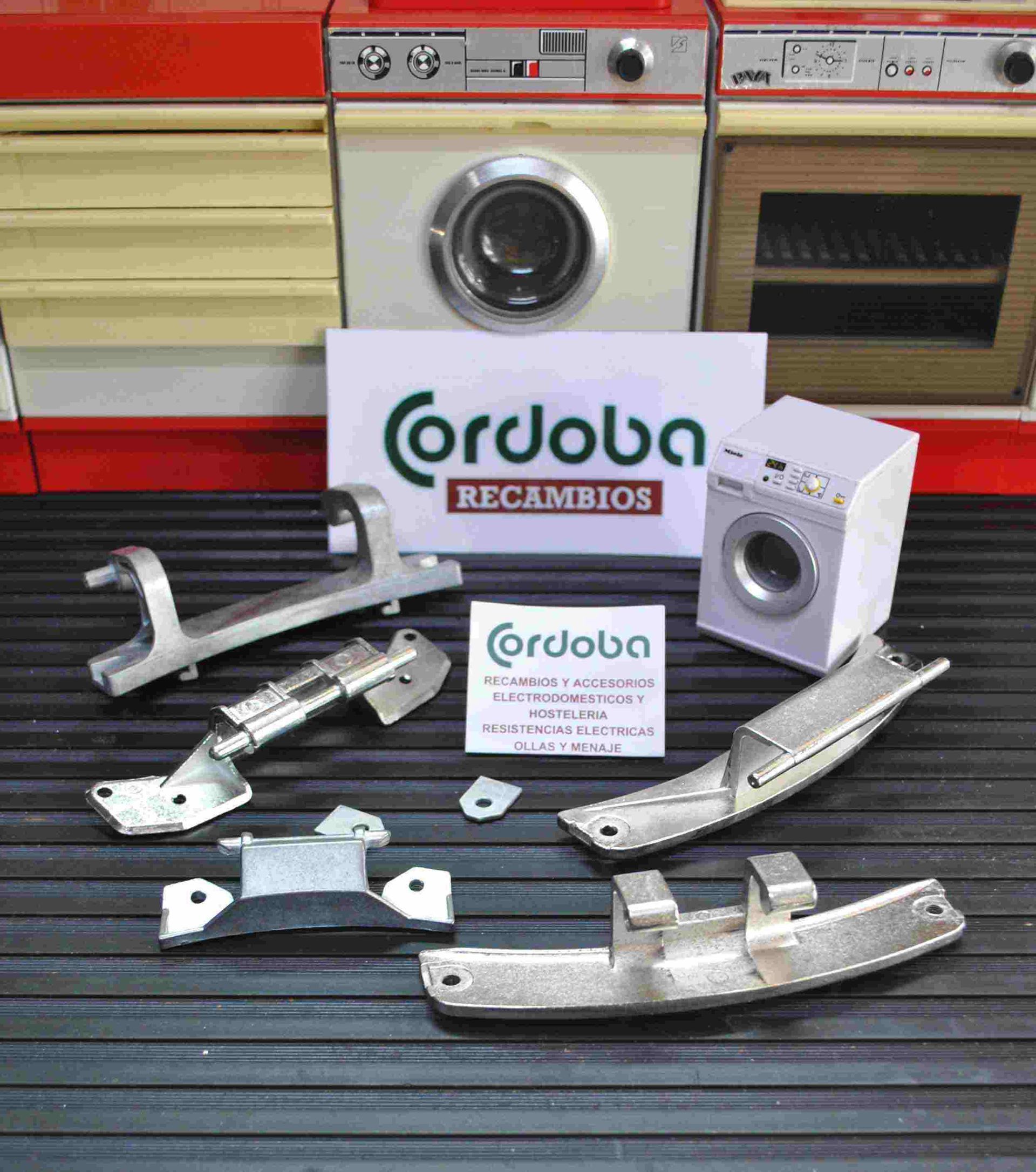 Una lavadora y una secadora están sobre una mesa al lado de un cartel que dice cordoba recambios.