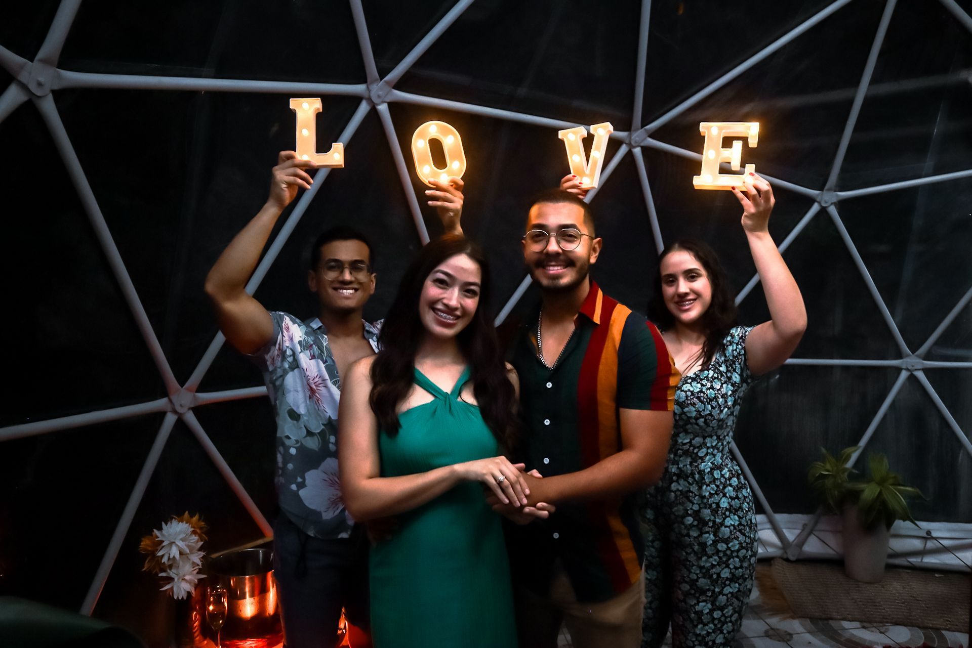 A group of people are holding up letters that spell out the word love.