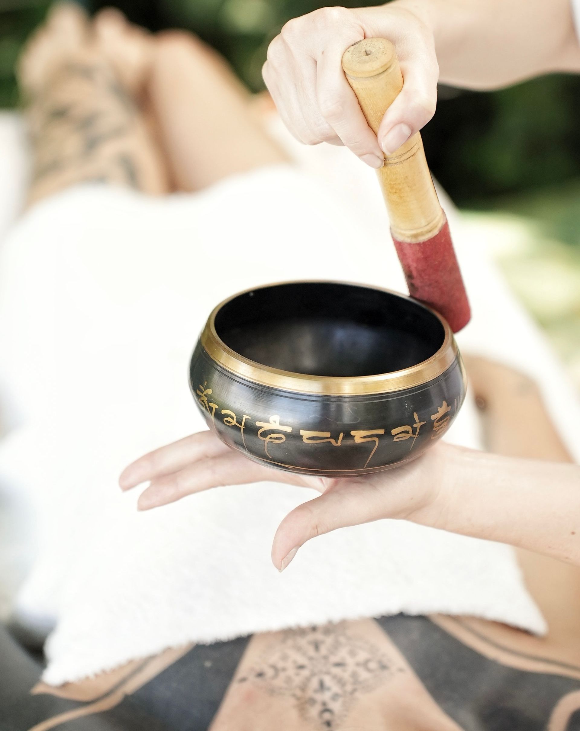 A person is holding a singing bowl in their hand