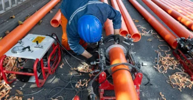 A man is working on the roof of a building.