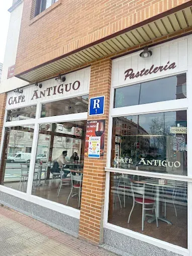 Un restaurante con mesas y sillas frente a un edificio de ladrillo.