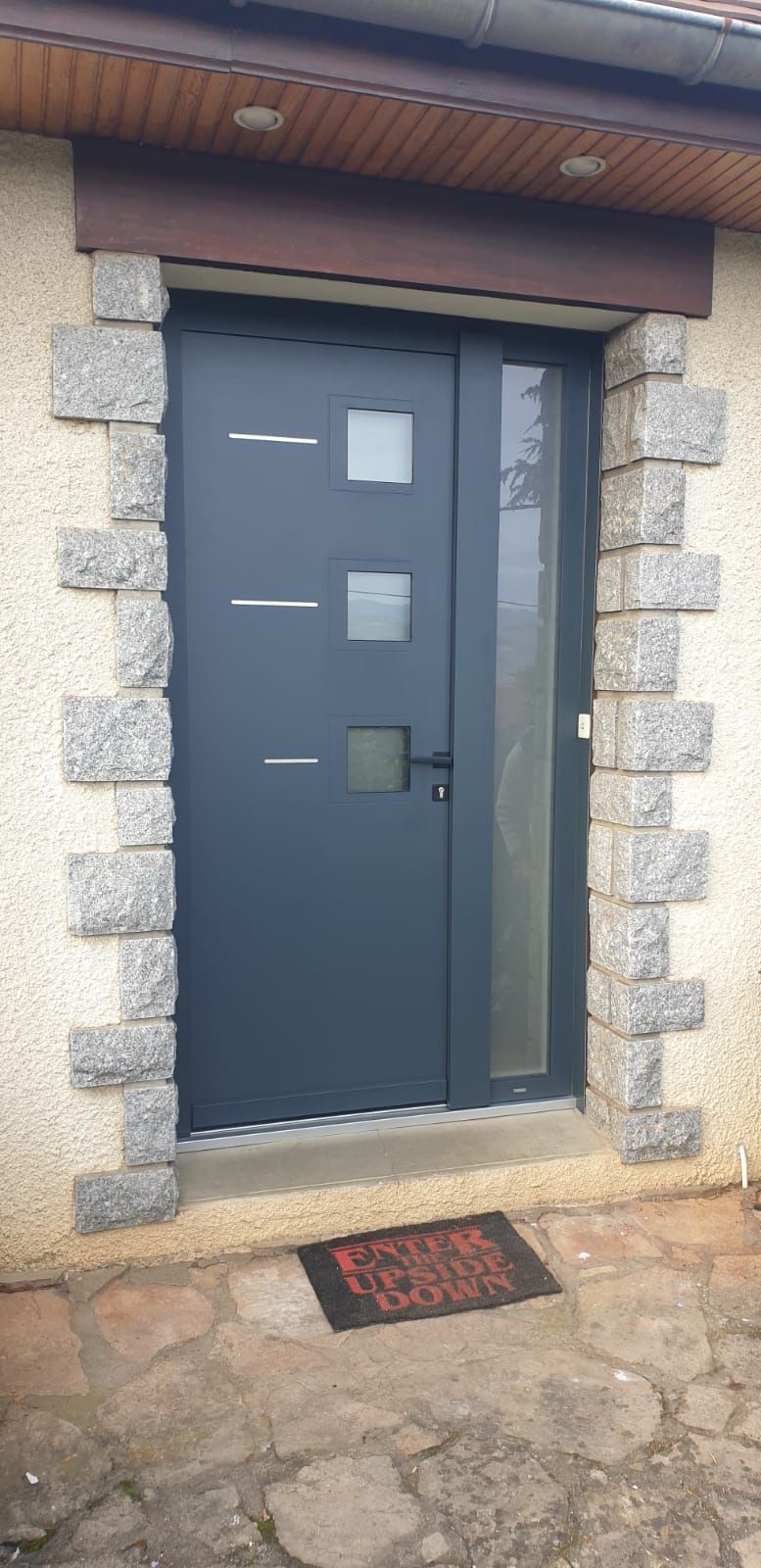 Porte d'entrée grise avec ouvertures vitrées